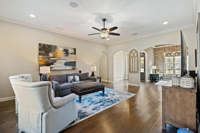 living room with crown molding, ceiling fan, and dark hardwood / wood-style flooring