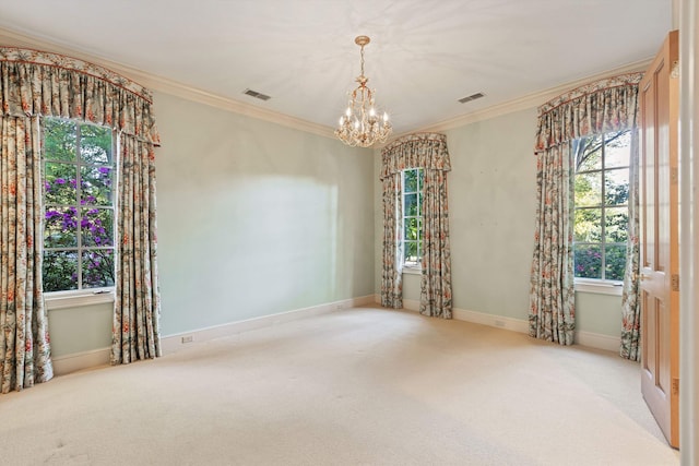 empty room with crown molding, a chandelier, and light colored carpet