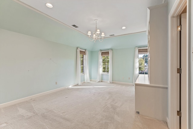 carpeted empty room with a chandelier