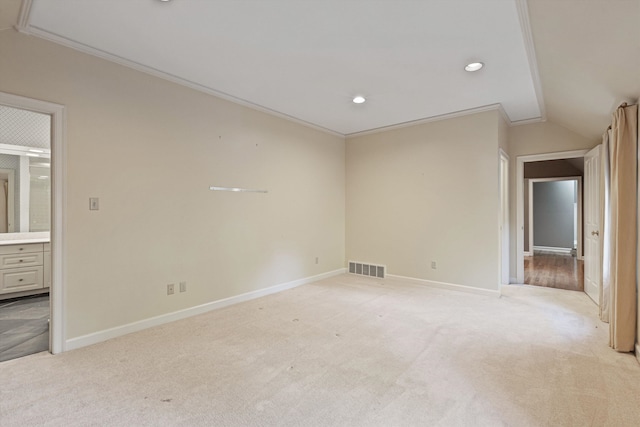 carpeted empty room with ornamental molding and lofted ceiling