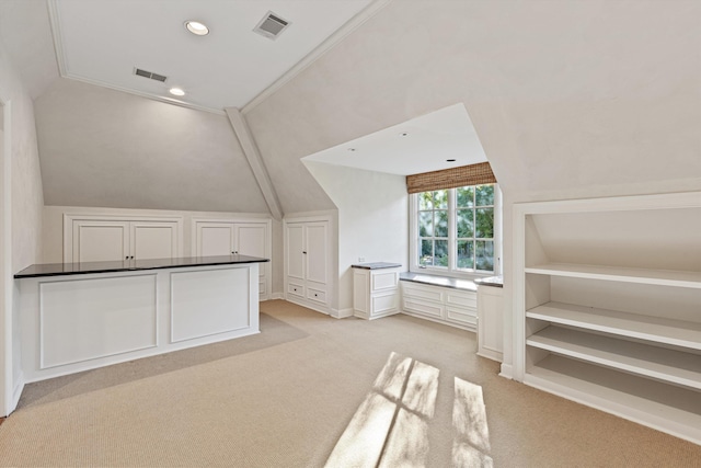 bonus room with light carpet and vaulted ceiling