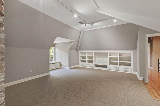 bonus room with lofted ceiling, hardwood / wood-style floors, and built in features