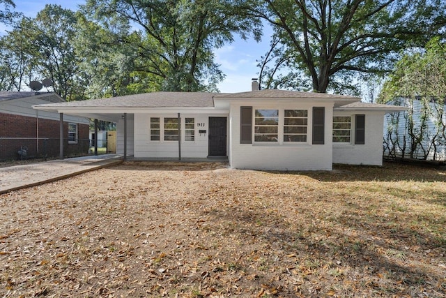 ranch-style home featuring a carport