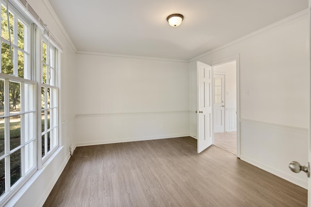 spare room featuring hardwood / wood-style flooring and crown molding