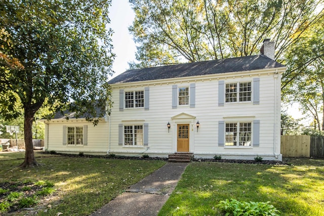 colonial-style house with a front lawn