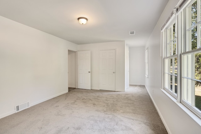 unfurnished room with light colored carpet