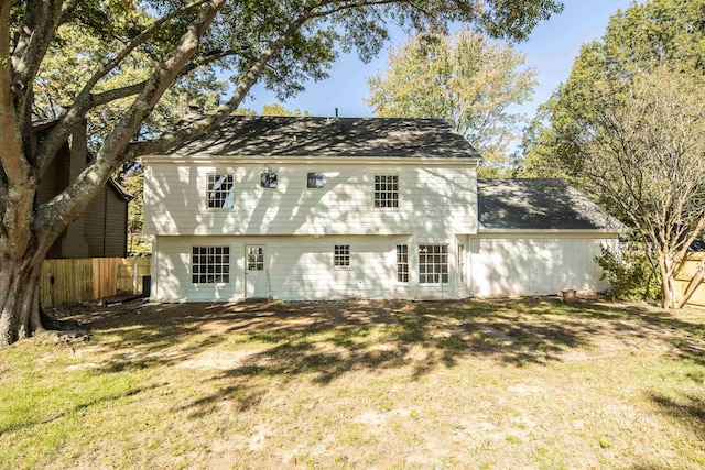 back of house with a lawn