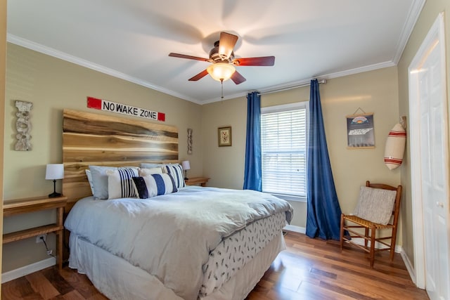 bedroom featuring ceiling fan, ornamental molding, and hardwood / wood-style floors