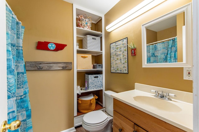 bathroom featuring vanity, a shower with shower curtain, and toilet