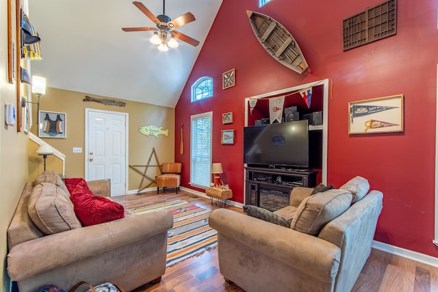 living room featuring a healthy amount of sunlight, high vaulted ceiling, and hardwood / wood-style floors