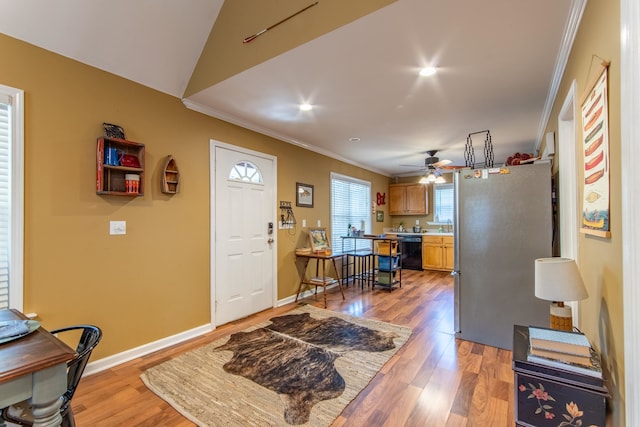 interior space with ornamental molding, light hardwood / wood-style floors, and ceiling fan