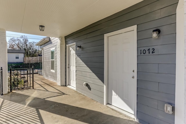 doorway to property featuring fence