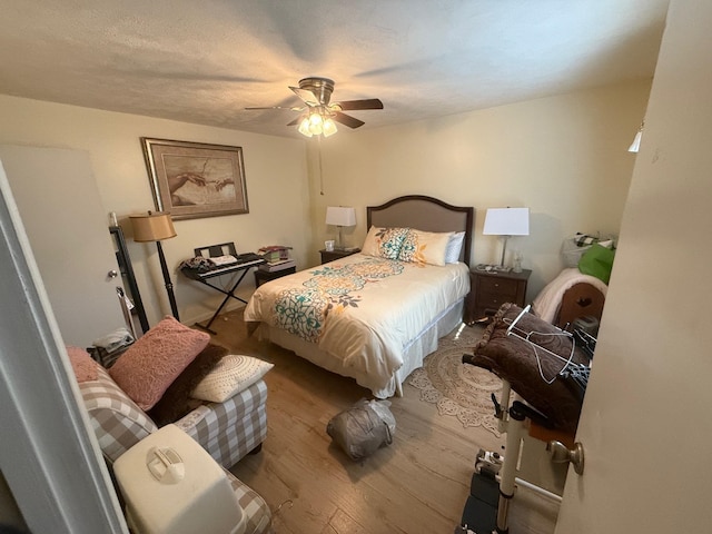 bedroom featuring hardwood / wood-style flooring and ceiling fan