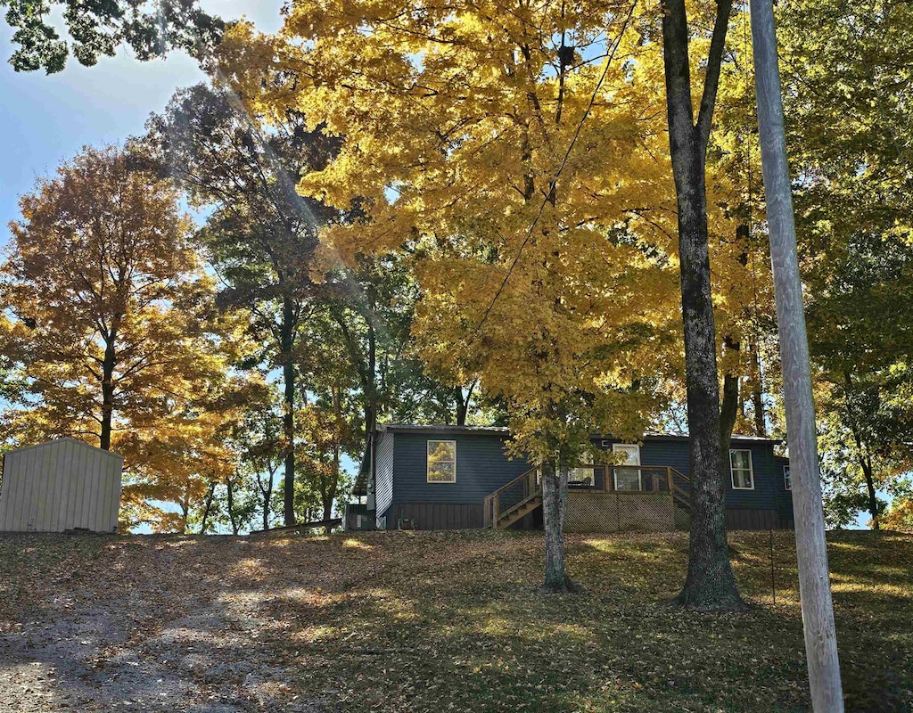 view of side of home with a storage unit