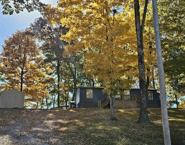 view of side of home with a storage unit