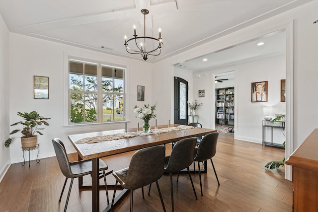 dining area with hardwood / wood-style flooring and a chandelier