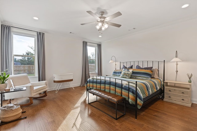 bedroom with ceiling fan, ornamental molding, and hardwood / wood-style floors