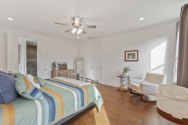 bedroom with connected bathroom, ceiling fan, hardwood / wood-style flooring, and ornamental molding