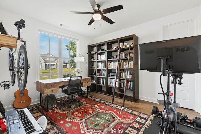 office space with hardwood / wood-style floors and ceiling fan