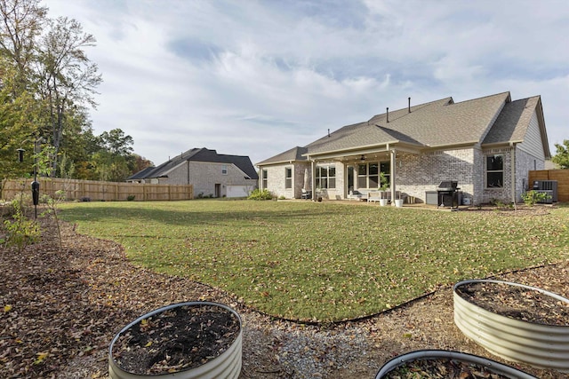 back of property with a patio area and a lawn