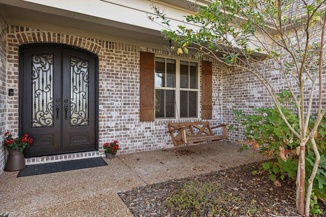 view of exterior entry featuring a porch