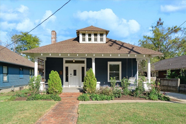 view of front of home with a porch and a front lawn