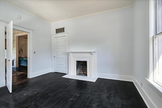 unfurnished living room featuring ornamental molding and dark hardwood / wood-style floors