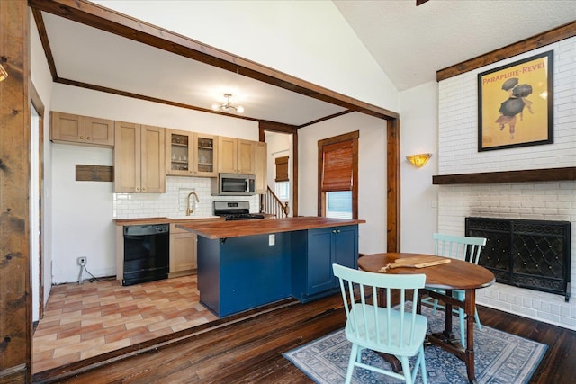 kitchen with dark hardwood / wood-style flooring, vaulted ceiling, stainless steel appliances, and wood counters