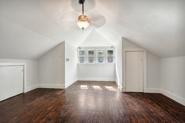 additional living space featuring vaulted ceiling and dark hardwood / wood-style floors