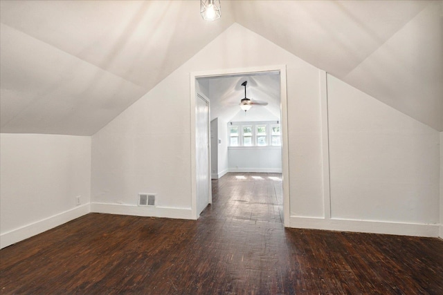 additional living space with ceiling fan, dark wood-type flooring, and vaulted ceiling