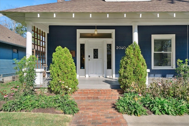 view of exterior entry featuring a porch