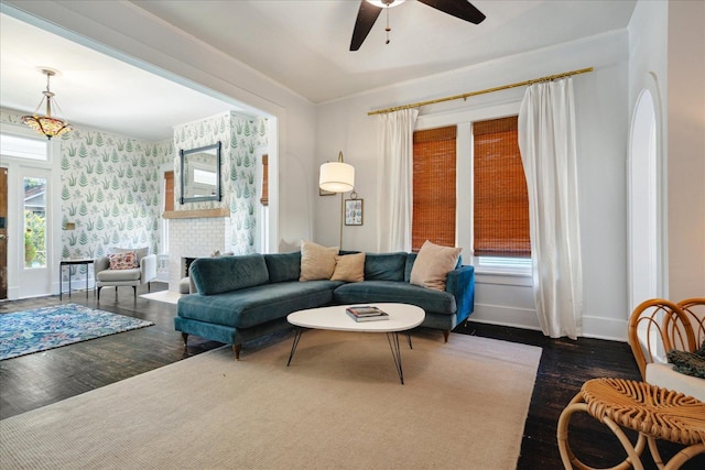 living room with dark hardwood / wood-style floors, a fireplace, and ceiling fan