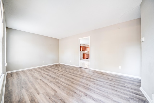 spare room with light hardwood / wood-style flooring