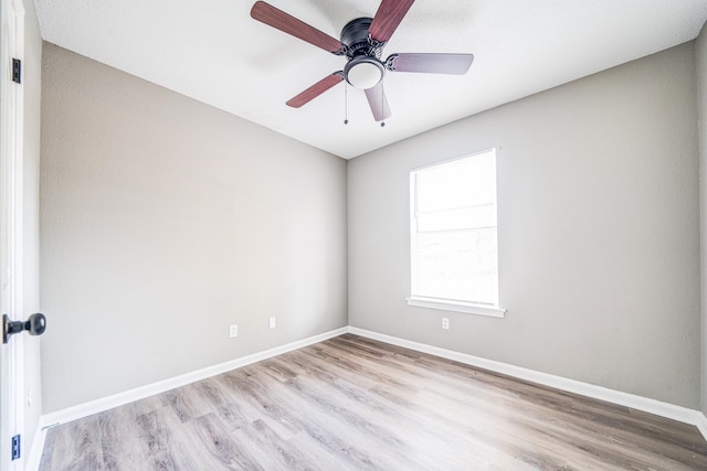 spare room featuring light hardwood / wood-style floors and ceiling fan