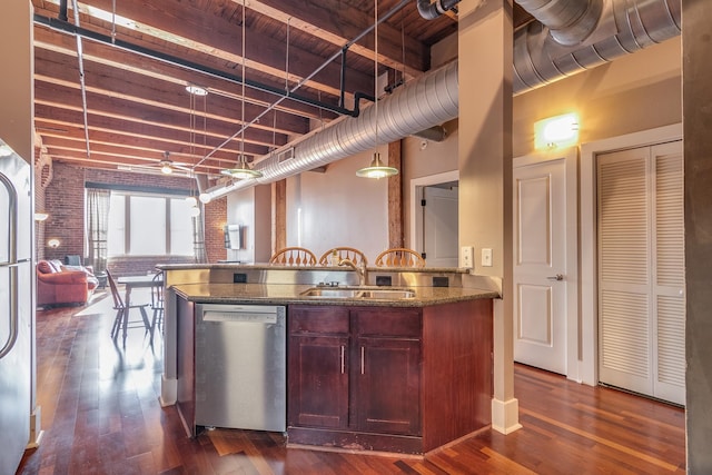 kitchen featuring dishwasher, dark hardwood / wood-style floors, hanging light fixtures, sink, and ceiling fan