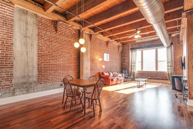 dining room featuring wood ceiling, ceiling fan, beam ceiling, hardwood / wood-style flooring, and brick wall