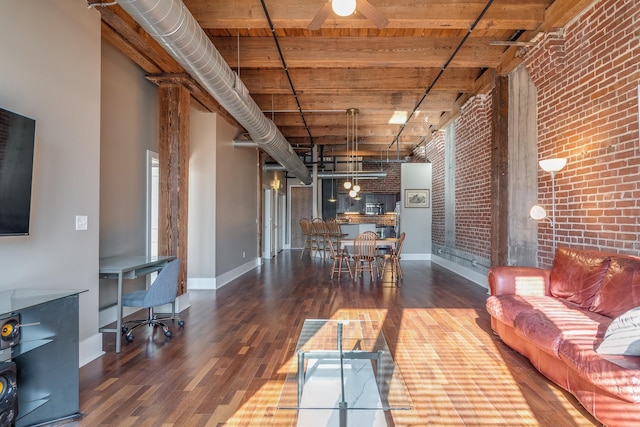 living room with wood ceiling, brick wall, a high ceiling, and dark hardwood / wood-style flooring