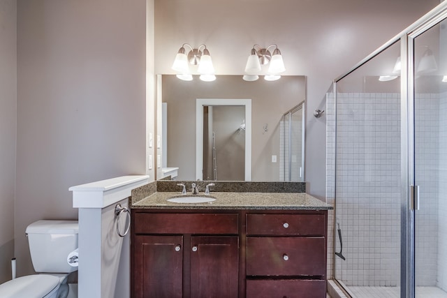 bathroom with vanity, walk in shower, and toilet