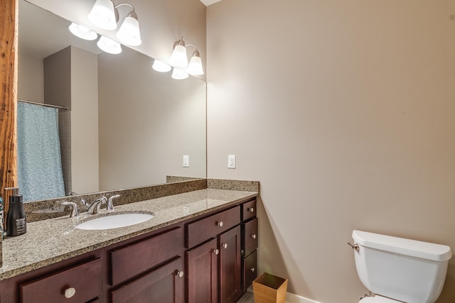 bathroom featuring toilet and vanity