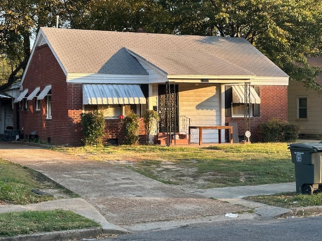 bungalow-style home with a front lawn