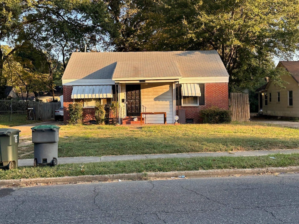 bungalow-style house featuring a front yard