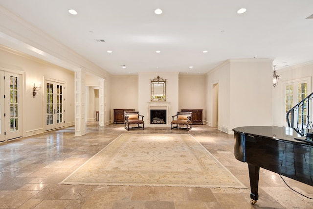 unfurnished room featuring decorative columns, crown molding, french doors, and plenty of natural light