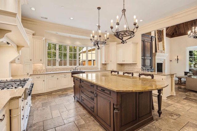 kitchen featuring a breakfast bar, light stone countertops, a center island, and backsplash