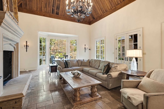 living room with a notable chandelier, wood ceiling, and high vaulted ceiling