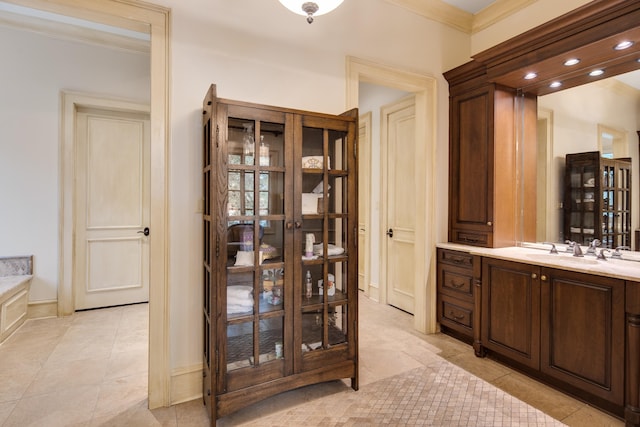 bathroom with vanity, crown molding, a bathtub, and tile patterned flooring