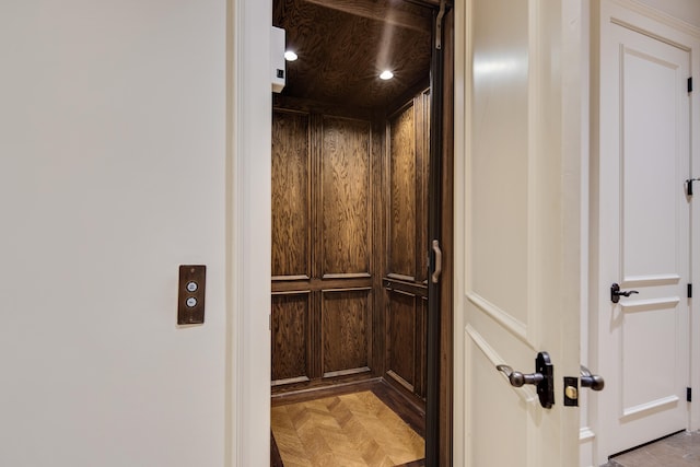 details featuring parquet flooring and elevator