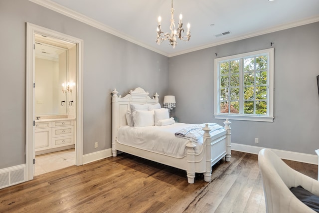 bedroom with ensuite bathroom, hardwood / wood-style flooring, a notable chandelier, and crown molding