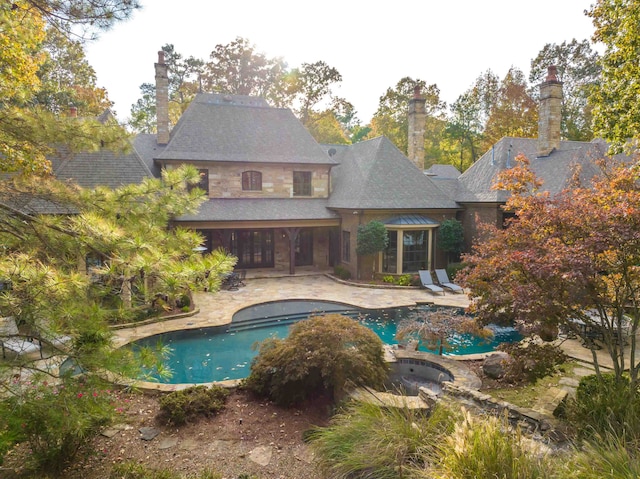 view of swimming pool with a hot tub and a patio area