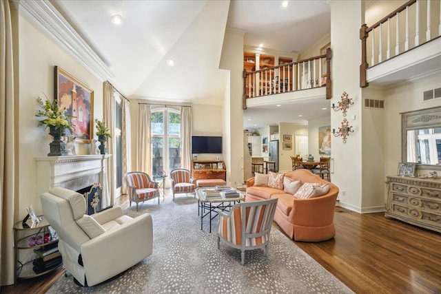 living room featuring ornamental molding, hardwood / wood-style floors, and high vaulted ceiling