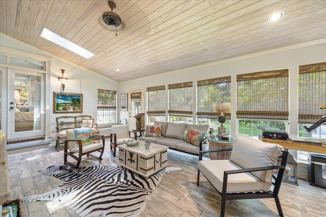 sunroom / solarium featuring lofted ceiling with skylight, a healthy amount of sunlight, and wooden ceiling